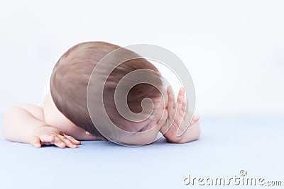 Baby girl sucking thumb - candid photo Stock Photo