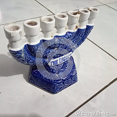 seven-pronged candle holder in blue and white with a white floor Stock Photo