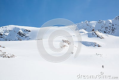 Youngs Peak above backcountry skier skinning uphill toward the Seven Steps of Paradise ski line Stock Photo