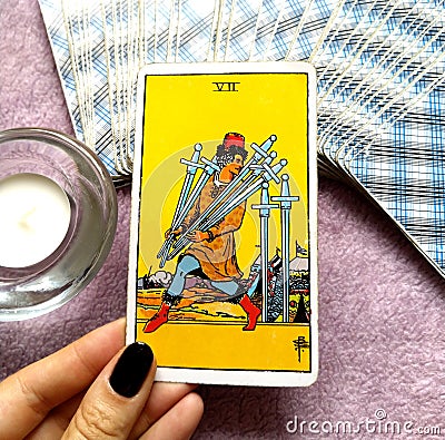 7 Seven of Swords Tarot Card Logic Reason Ahead of the Posse Adaptability Flexibility Plotting & Planning Strategies Stock Photo