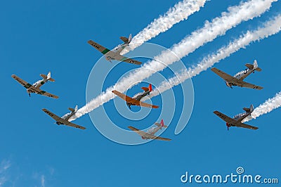 Seven AT-6 Texans Fly Over Trailing Smoke Editorial Stock Photo