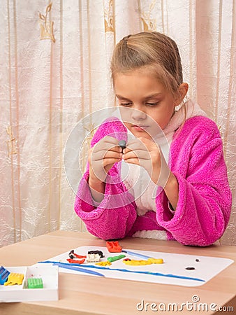 Seven-year girl with enthusiasm sculpts Stock Photo