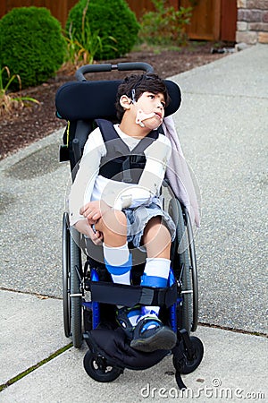 Seven year old biracial disabled boy in wheelchair Stock Photo