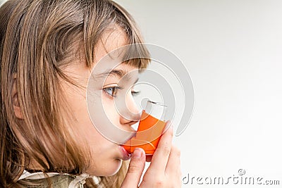 Seven year old girl breathing asthmatic medicine healthcare inhaler Stock Photo