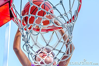 Seven year old girl playing basketball Stock Photo