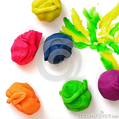 Several balls of multicolored plasticine on the white background. Stock Photo