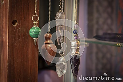 Several Beautiful Crystal Pendulums Hanging on Display Stock Photo