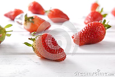 Several berries of red ripe strawberries on the white wooden surface Stock Photo