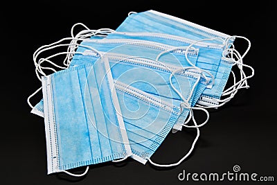 Several blue protective masks on a black background Stock Photo
