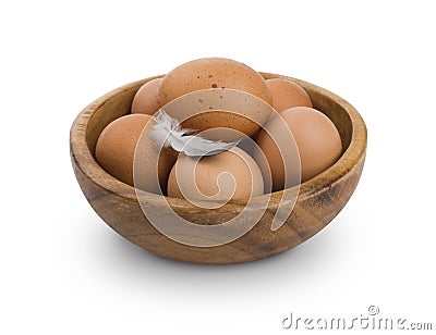 Several brown Eggs in wooden bowl isolated on white background Stock Photo