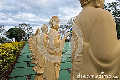 Several Buddha statues in perspective at the buddhist temple Editorial Stock Photo