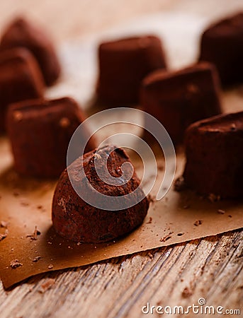 Several chocolate truffles on wooden board Stock Photo