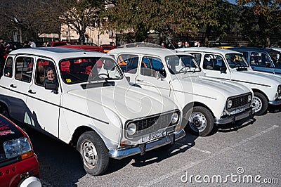 Several classic white Renault 4 cars parked in line with a granny inside Editorial Stock Photo