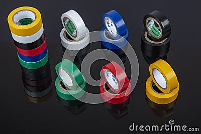 Several coils of colored tape insulating tape on black background. Adhesive tape Electrical tapes on a black background. View Stock Photo