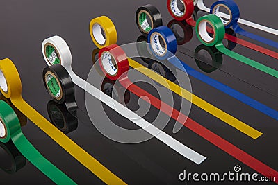 Several coils of colored tape insulating tape on black background. Adhesive tape Electrical tapes on a black background. View Stock Photo