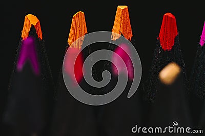 several colored pencils, brightly colored tips with selective focus, black background. Stock Photo