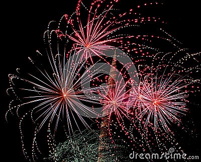 Several colorful fireworks exploding in the dark sky in the middle of the night. The explosions light the sky creating colorful Stock Photo