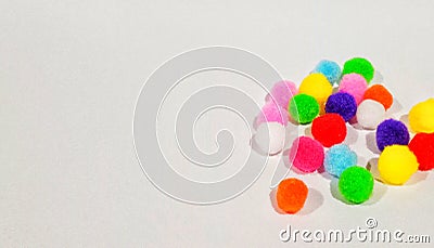 several colorful little poms on a white background Stock Photo