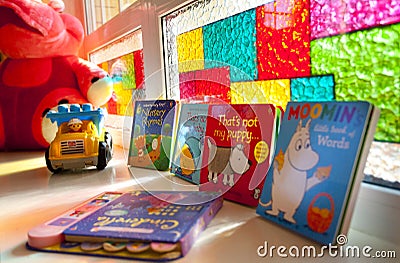 Several colorful books, toy car and children truck Editorial Stock Photo