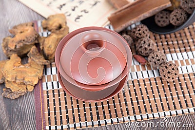 Several common Chinese herbal medicines and a purple sand tea bowl type medicine bowl Stock Photo