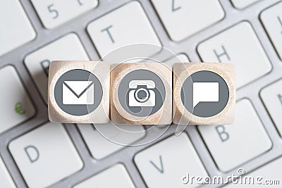 Several contact options as icon on little cubes on keyboard Stock Photo