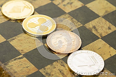 Several cryptocurrencies, bitcoin, ethereum, litecoin, ripple on chessboard Editorial Stock Photo
