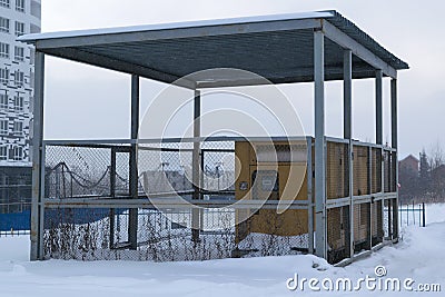 Several diesel generators stand under a canopy is fenced with a metal grid Stock Photo
