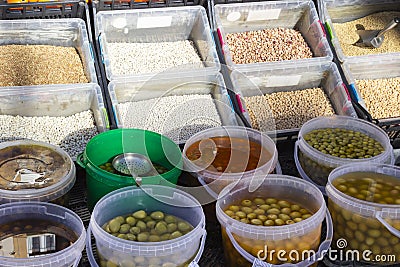 Several different types of olives in translucid cups at the street market Stock Photo