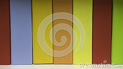 Several folders in a row in the rack with color coding Stock Photo