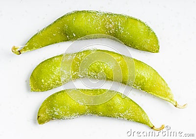 Several frozen Edamame pods close up on gray Stock Photo