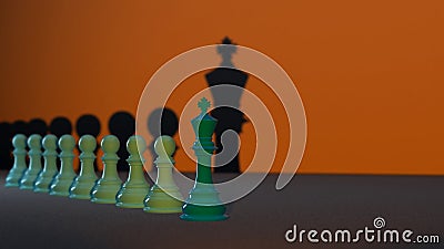 Several green Chess Pawns lined up with the Chess King at the forefront, the concept of leadership in an organization Stock Photo