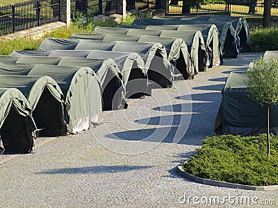 Several large military tents on the paved area Stock Photo