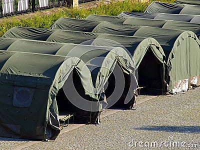 Several large military tents on the paved area Stock Photo