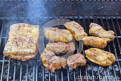 Several large pieces of bacon are grilled smoked on a BBQ Stock Photo