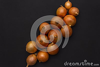 Several large yellow bulbs onion on a dark black background Stock Photo
