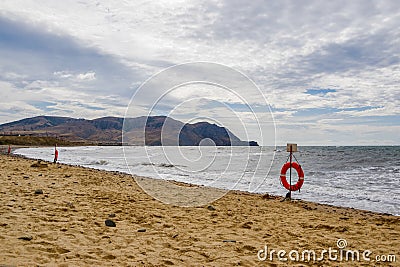 Several lifebuoys on a sandy sea beach Stock Photo