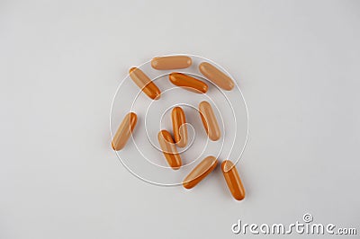 Several long orange colored tablets. Stock Photo