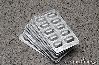 Several many medication pills in reflective opaque silver packaging Stock Photo