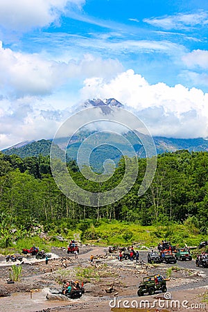 Several offroad cars are offroading on a shallow river, seen from a distance, with a beautiful view Editorial Stock Photo