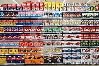 Several packs of coffee on a wall of shelves. Front view, full background. Editorial Stock Photo