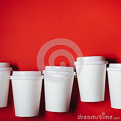 Several paper cups on red background Stock Photo