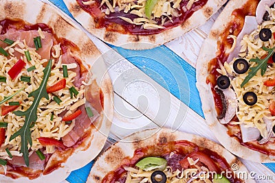 Several pizzas on striped background Stock Photo