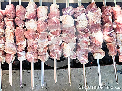 raw skewered shish kebabs on brazier with hot coal Stock Photo
