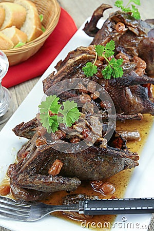 Roasted pigeon with currants Stock Photo