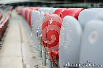 Several rows of red and white stadium seats Stock Photo