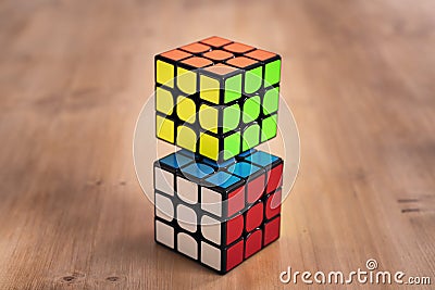 Madrid, Spain; 9 february 2019: Several Rubik cubes intelligence toys solved, in a wood table Editorial Stock Photo