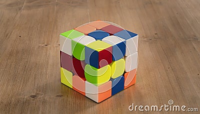 Budapest, Hungary; 9 february 2019: Several Rubik cubes intelligence toys unsolved, in a wood table Editorial Stock Photo