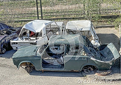 several rusting cars after accidents without wheels without windows in a landfill Stock Photo