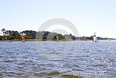 Several sailing boats in a lake near the coast Stock Photo