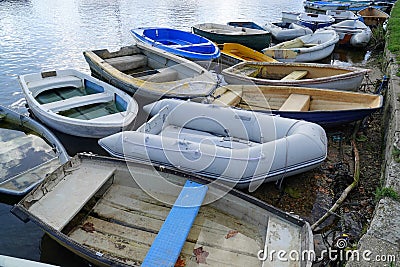 Several small boat dinghies moored in harbour Stock Photo